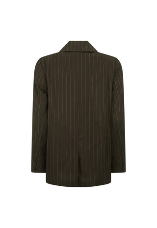 A woman models a brown pinstripe blazer over a matching brown lace-up top and shorts